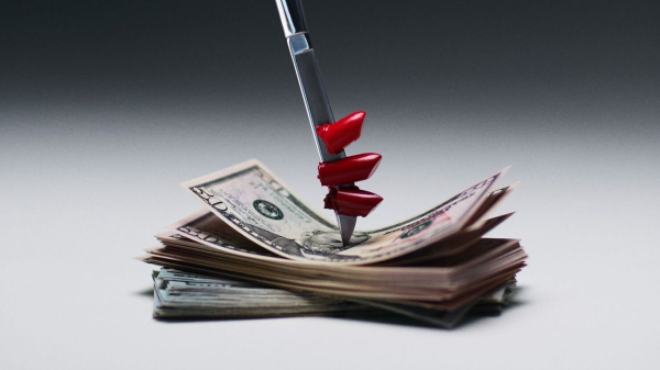Knife with lipstick on the blade stabbing stack of money